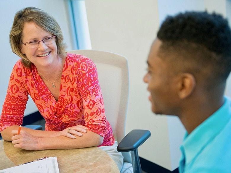 Male student with female career adviser